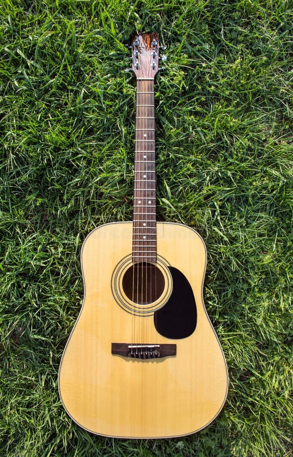 Acoustic Guitar On The Grass Stock Photo - Image of play, popular: 55956078