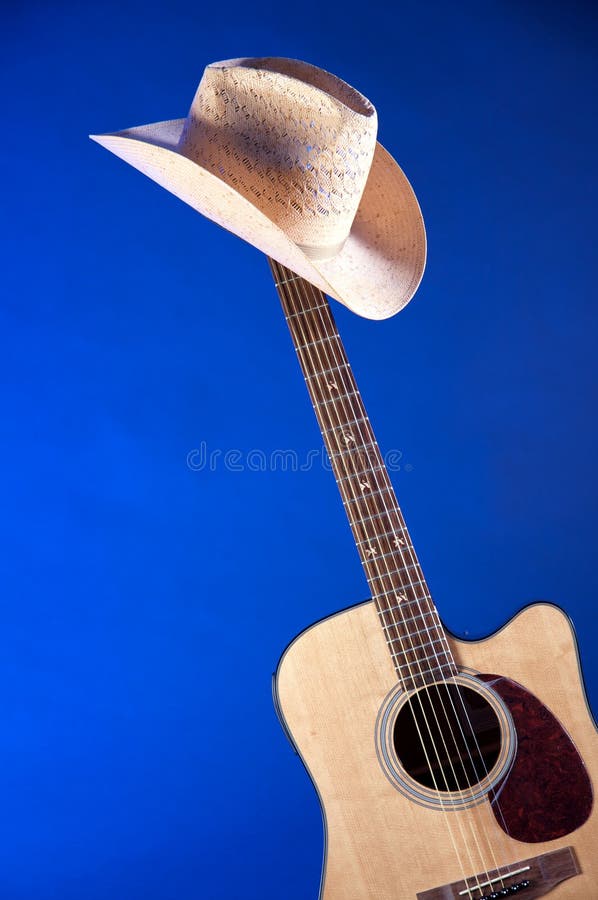 Acoustic Guitar With Hat On Blue