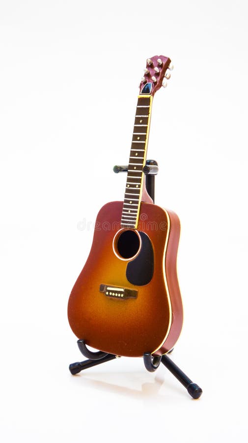 Red Guitar Model Toy on Stand in White Background Stock Photo Image