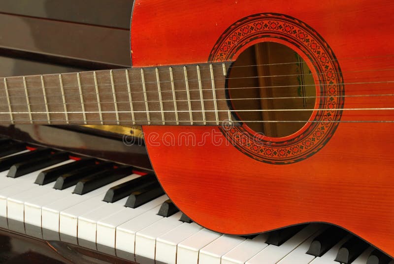 Acoustic Guitar on Piano Keyboard Stock Photo - Image of instrument