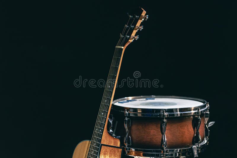 Acoustic Guitar and Snare Drum on a Black Background Isolated. Stock