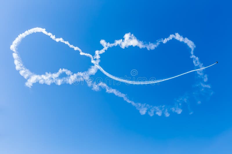 Acrobatic airplane with smoke on the airshow