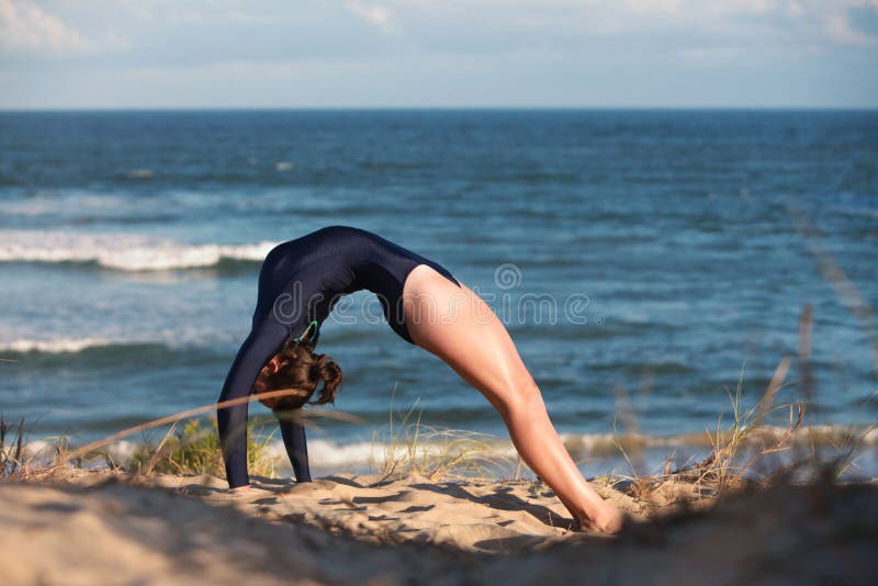 Acrobatic Gymnast is Doing the Split on the Beach Stock Image Image