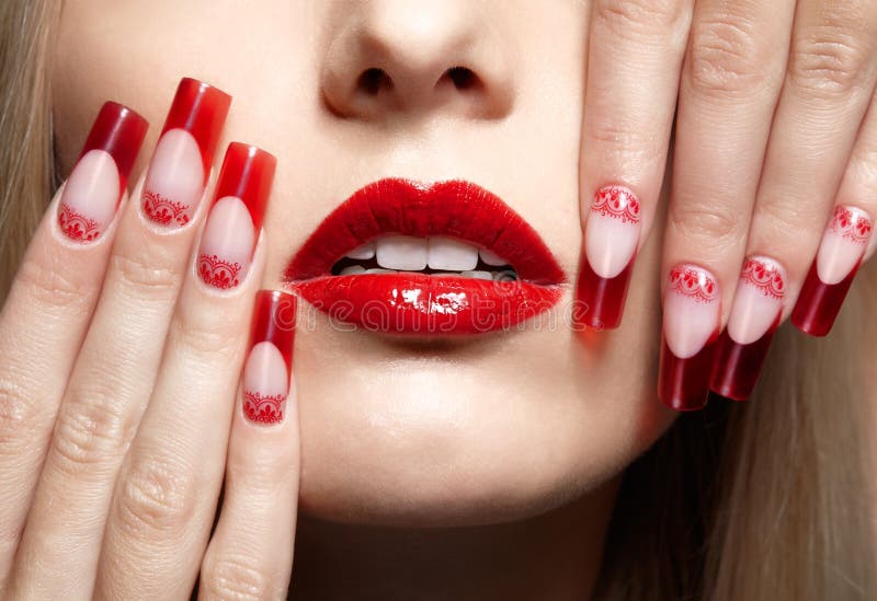 Fingers with red french acrylic nails manicure and paiting. Fingers with red french acrylic nails manicure and paiting