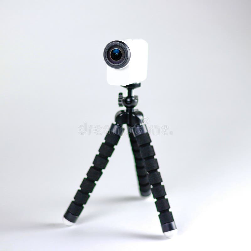 Action camera on a small tripod. Close up. Isolated on white background.