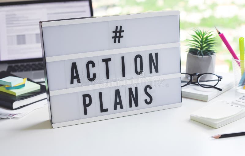 Action plan text on light box on desk table in office. Business motivation stock photos