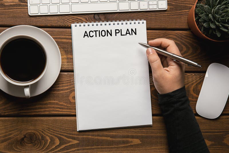 Action Plan - text on notepad on working table, top view royalty free stock image