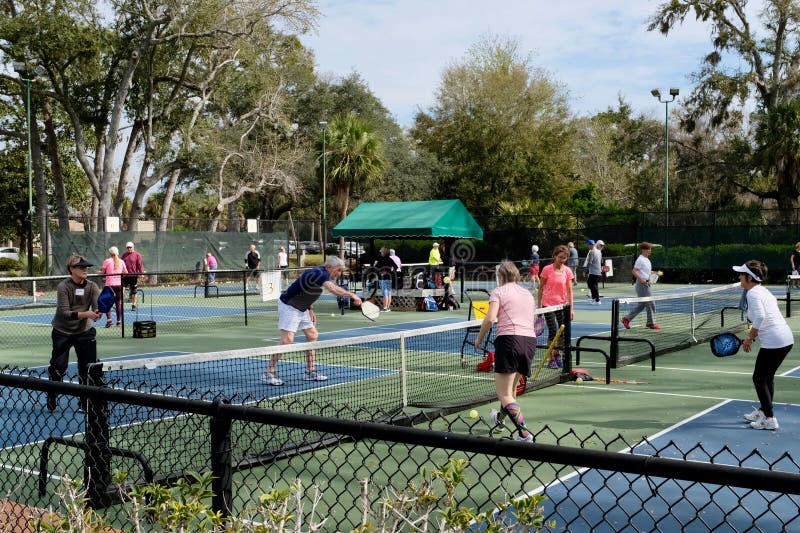 Active Adults Playing Pickleball Outdoors