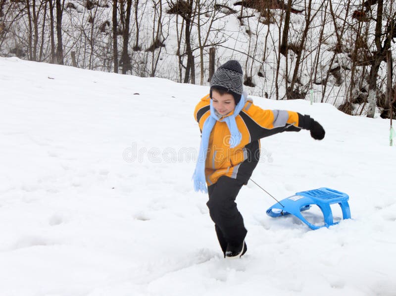 Active boy enjoying a sleigh ride outdoor stock images Active boy enjoying a sleigh ride outdoor stock images