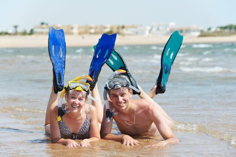 Active couple at sea beach with snorkel set royalty free stock image Active couple at sea beach with snorkel set royalty free stock image