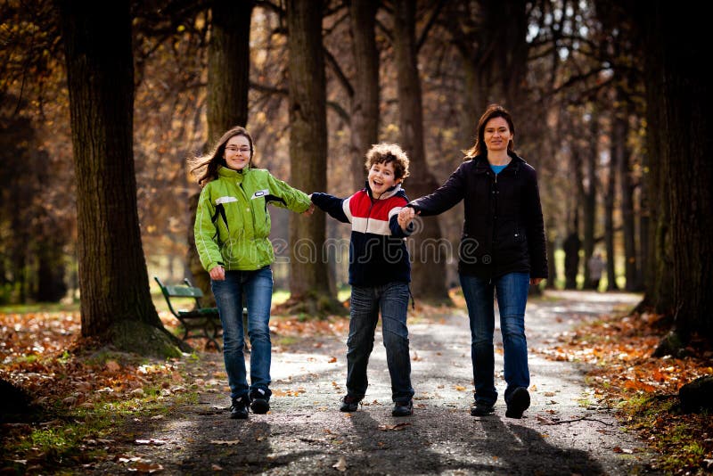Active family - mother and kids walking outdoor
