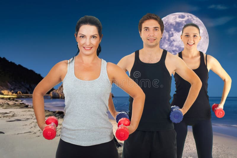 Active Group of Smiling Friends Enjoying Beach Exercise stock image