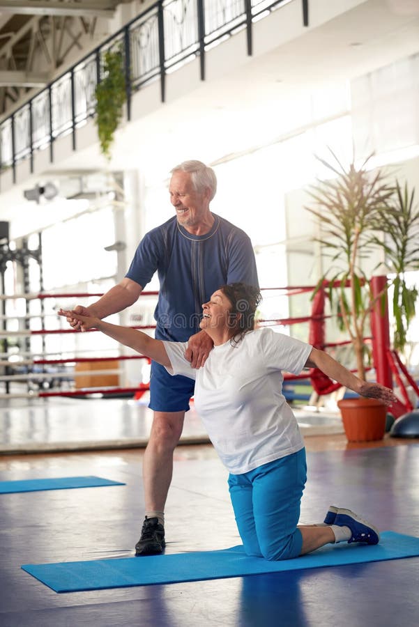Active happy elderly couple exercising in gym. royalty free stock image Active happy elderly couple exercising in gym. royalty free stock image