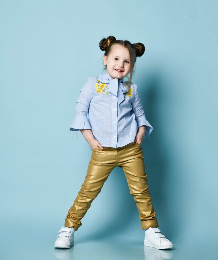 Active Cheerful Baby Kid Girl in Blue Shirt and Gold Leather Pants