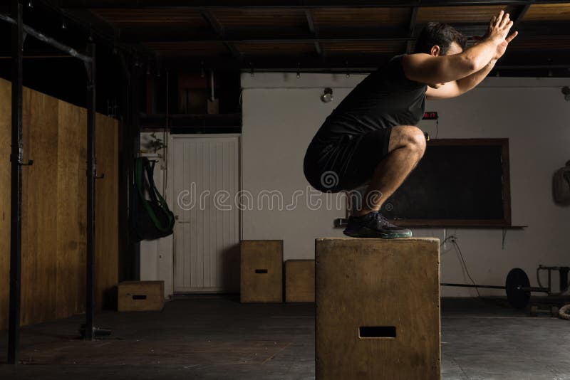 Active Man Doing Box Jumps in a Gym Stock Photo Image of exercise