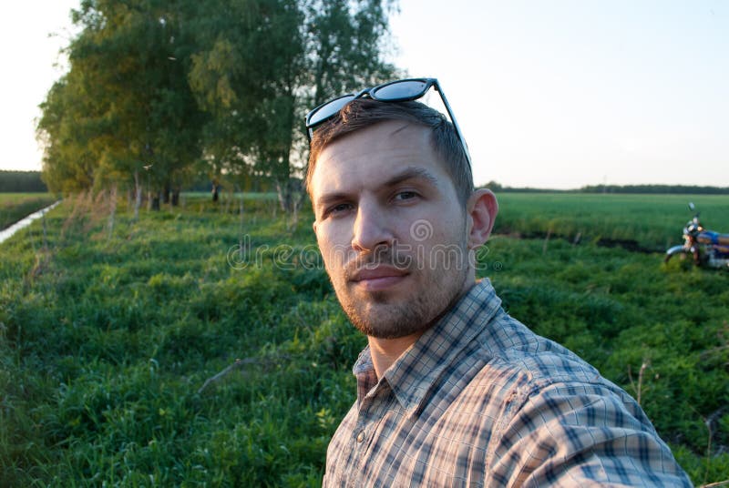 Active man in glasses taking a selfie outdoors