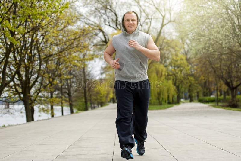 Active man joging in park. Runing fit.