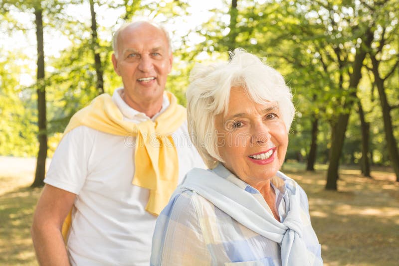 Happy active older couple spending time in the forest