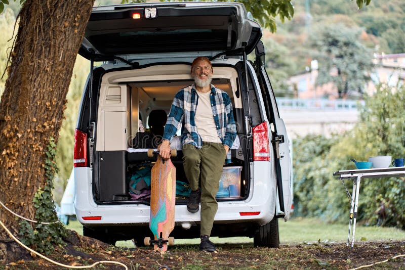 Active Older Hipster Man Standing Near Rv Camper Van Holding Skateboard ...