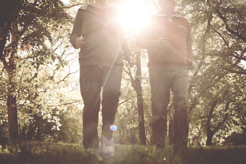 Active senior couple jogging together in park. stock photo Active senior couple jogging together in park. stock photo