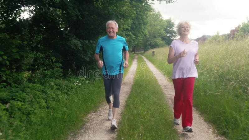 Active senior man and woman running for better fitness