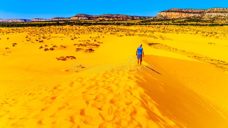 Active Senior Woman hiking the Sand Dunes in the Coral Pink Sand Dunes State Park, Utah