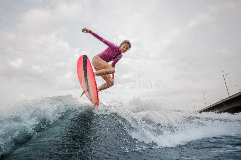 Active teenager girl jumping on the wakeboard royalty free stock photography Active teenager girl jumping on the wakeboard royalty free stock photography