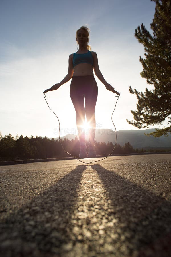 Active woman jumping with skipping rope stock photo Active woman jumping with skipping rope stock photo