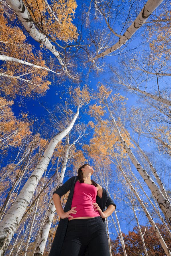 Active young girl resting in a birch grove