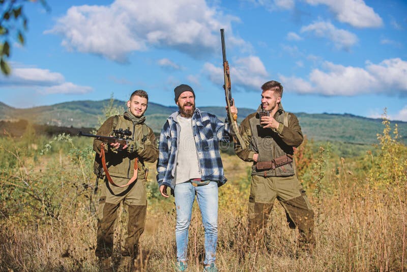 Activity for real men concept. Hunters gamekeepers looking for animal or bird. Hunters with rifles in nature environment stock images Activity for real men concept. Hunters gamekeepers looking for animal or bird. Hunters with rifles in nature environment stock images