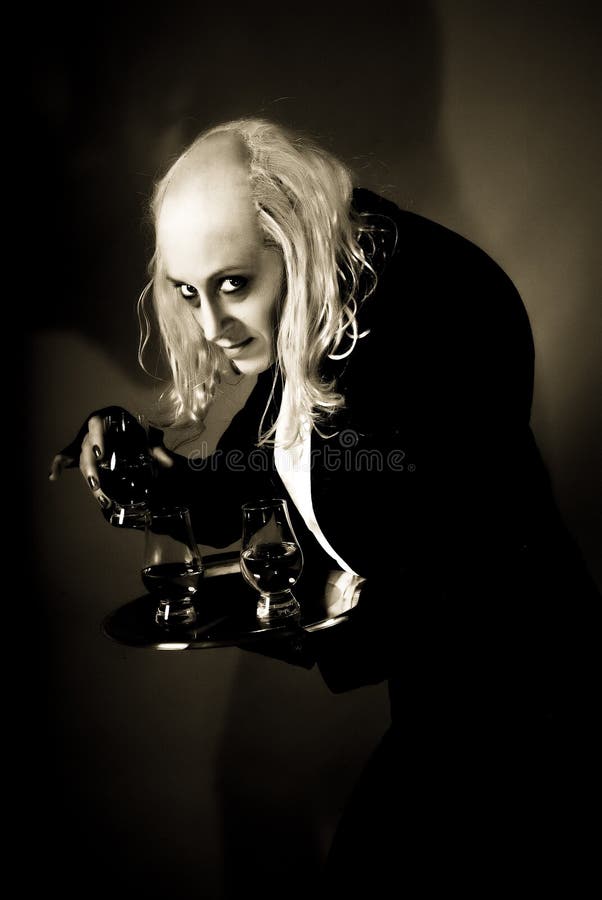 Actor playing Riff Raff. Young female actor in costume playing part of Riff Raff in Rocky Horror show, black background stock photography Actor playing Riff Raff. Young female actor in costume playing part of Riff Raff in Rocky Horror show, black background stock photography