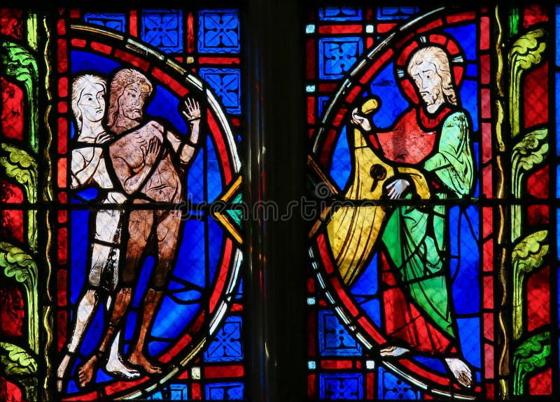 Stained glass window depicting Adam and Eve in the Cathedral of Tours, France. Stained glass window depicting Adam and Eve in the Cathedral of Tours, France.