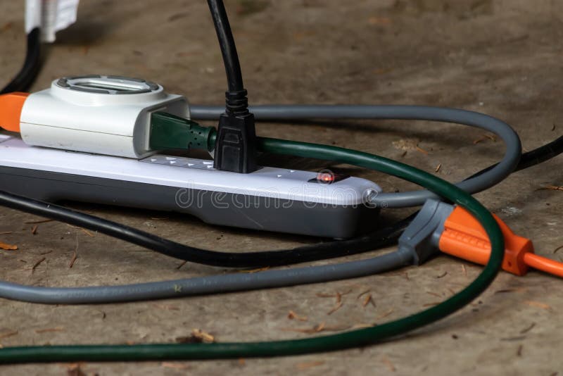 Adapter with Multiple Outlets and Plugs Sitting Outside Stock Image