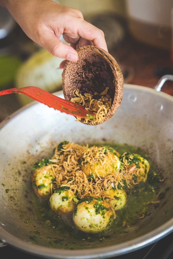 Adding Anchovy into Stirfry Egg and Green Chili Sauce Stock Image