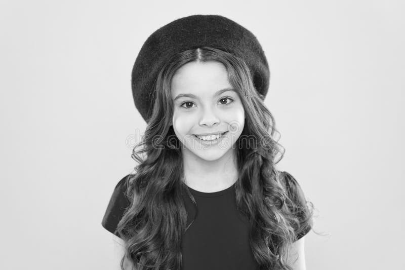 Adding an edge to the classic French look. Small child smiling with fashion look. Happy little girl wearing red beret stock images Adding an edge to the classic French look. Small child smiling with fashion look. Happy little girl wearing red beret stock images