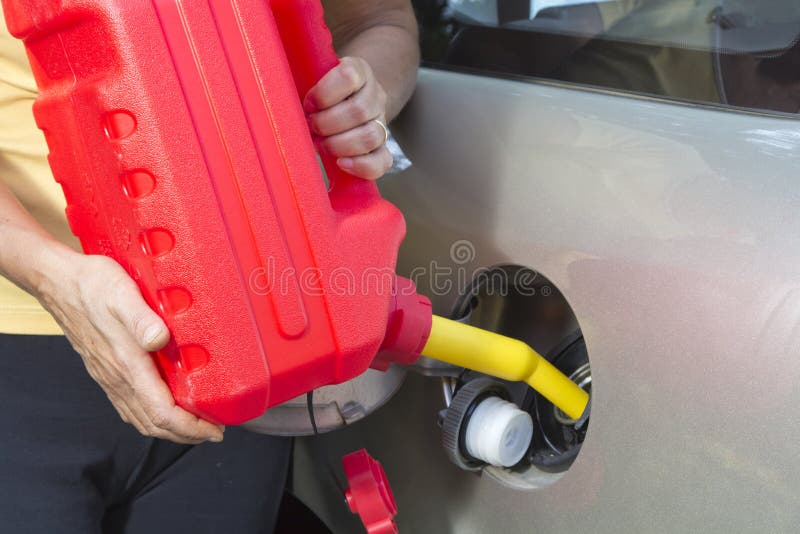 Adding fuel in car with Red Plastic Gas can
