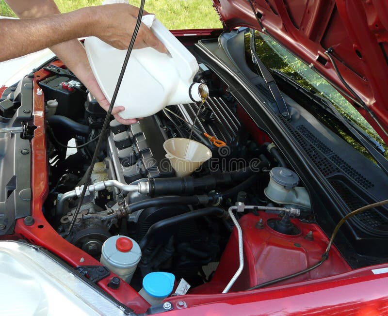 Adding Motor Oil to Car stock photo. Image of adding 16753358