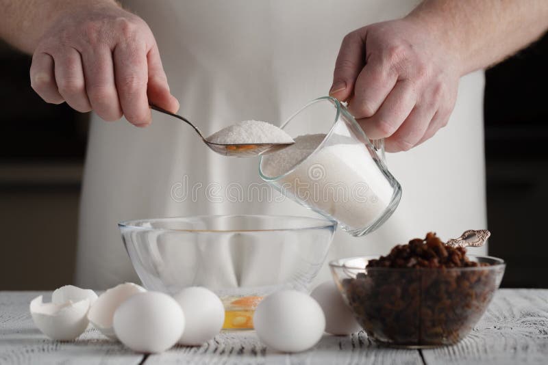 adding sugar to cottage cheese in a bowl. Prepares mini cheesecakes with strawberries stock photography adding sugar to cottage cheese in a bowl. Prepares mini cheesecakes with strawberries stock photography