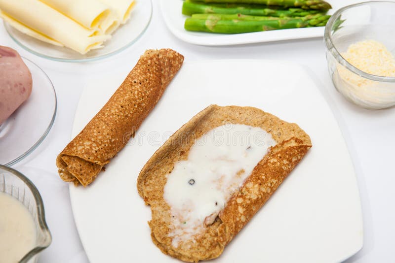 Adding White Sauce To the Quinoa Crepes Stock Photo Image of culinary