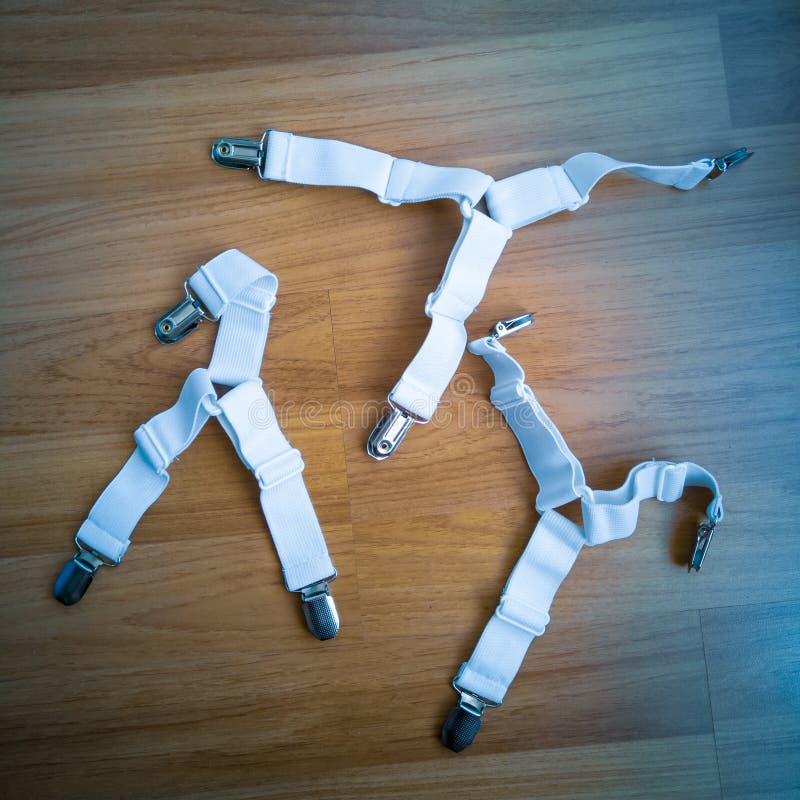 Adjustable Bed Straps in White Colour on a Wooden Floor Stock Photo
