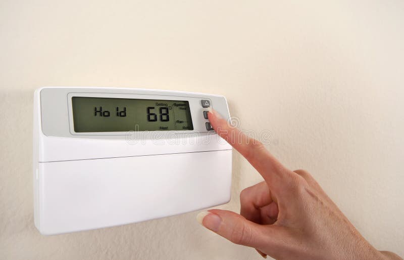 Adjusting and setting thermostat stock images