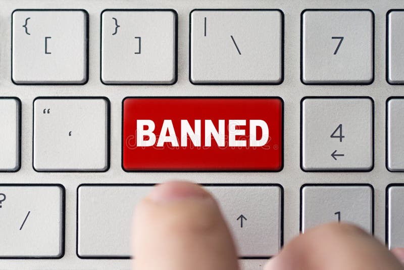 admin bans the user. The red button on the keyboard of a notebook with the inscription of banned. The concept of blocking in the Internet. admin bans the user. The red button on the keyboard of a notebook with the inscription of banned. The concept of blocking in the Internet