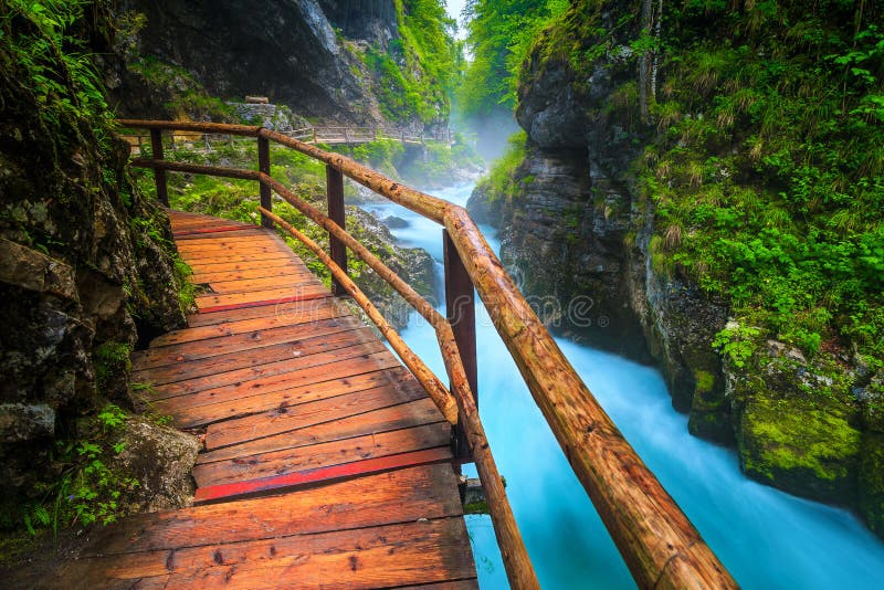 Noisy Radovna river in Vintgar gorge with wooden footbridge, Slovenia