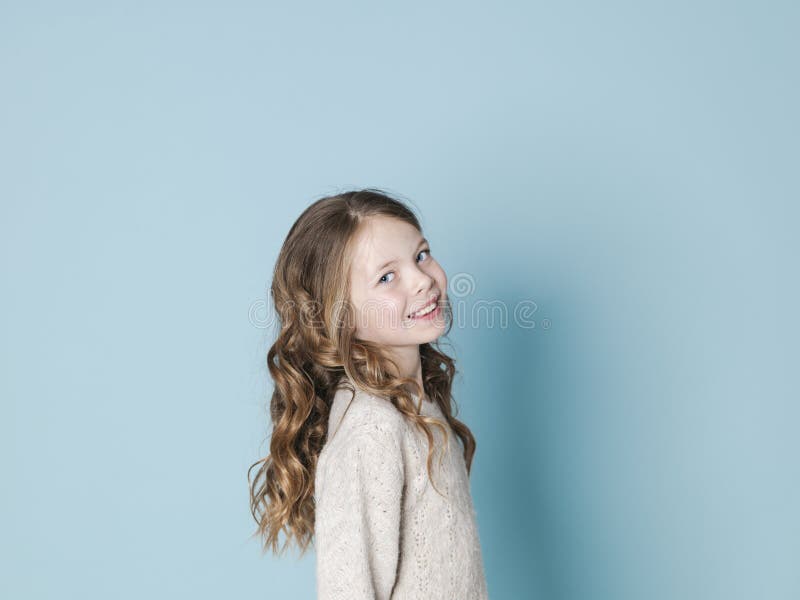 Pretty And Cool 9 Year Old Girl With Brown Wool Sweater Posing In Front