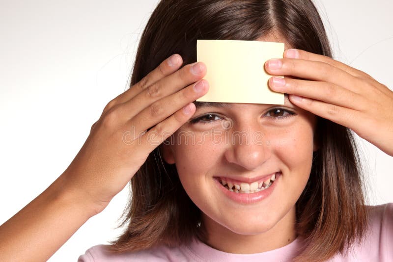 Adolescent face with a blank yellow sticky note