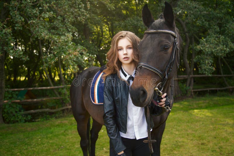 Adolescente della ragazza con un cavallo fotografia stock libera da diritti Adolescente della ragazza con un cavallo fotografia stock libera da diritti