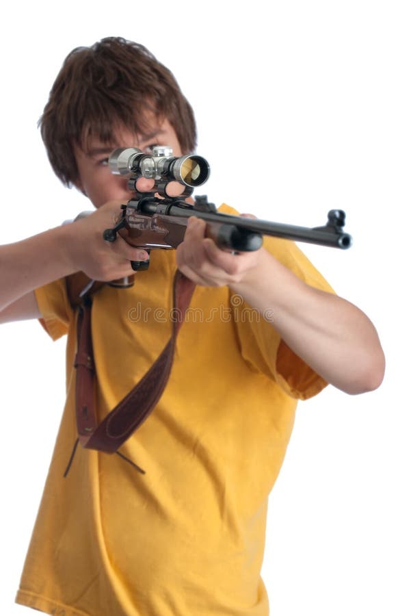 Teenage boy looking through a rifle scope. Teenage boy looking through a rifle scope
