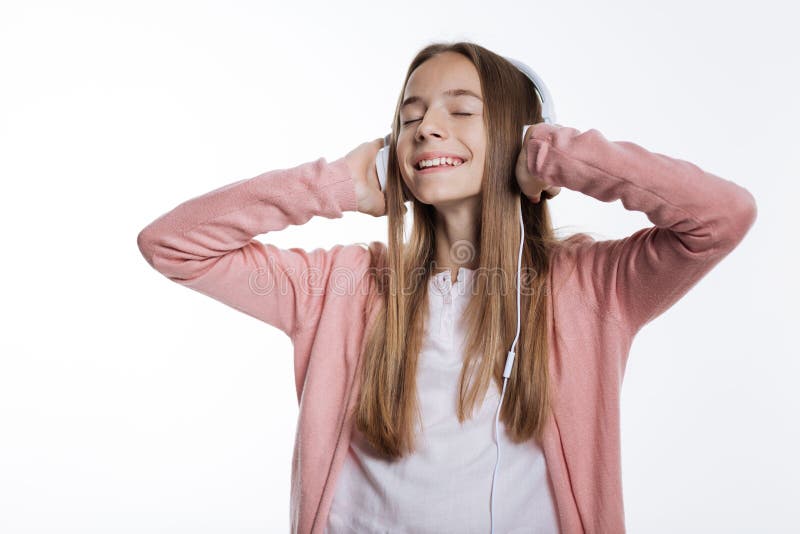 Adolescente que aprecia músicas favoritas nos fones de ouvido fotografia de stock Adolescente que aprecia músicas favoritas nos fones de ouvido fotografia de stock