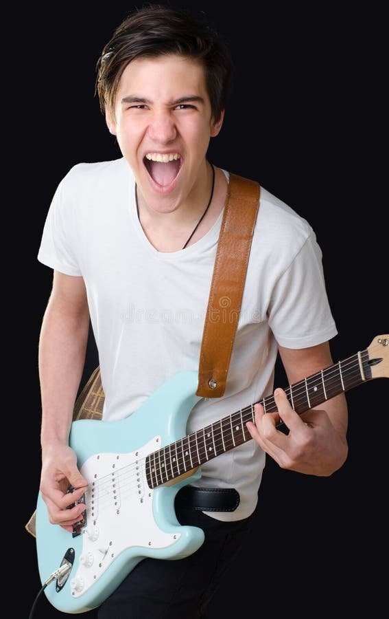 Adolescente que toca la guitarra eléctrica y que canta imagenes de archivo Adolescente que toca la guitarra eléctrica y que canta imagenes de archivo