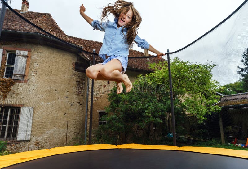 Adolescente sveglio che salta sul trampolino immagine stock libera da diritti Adolescente sveglio che salta sul trampolino immagine stock libera da diritti